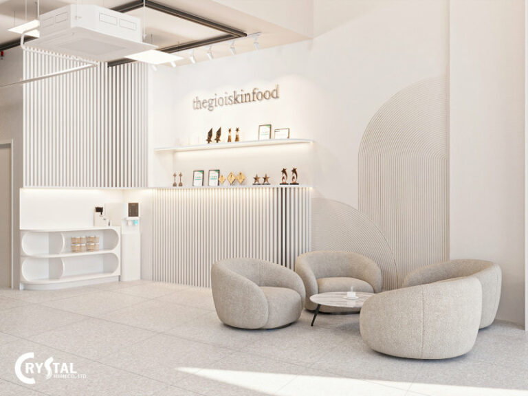 Không gian spa màu trắng tinh khôi, quầy lễ tân thiết kế sóng động, ghế sofa tròn êm ái và bàn trà nhỏ nhắn