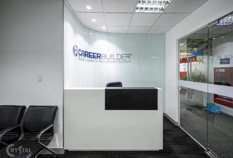 Văn phòng CareerBuilder hiện đại với quầy lễ tân trắng nổi bật và ghế chờ tối giản.
