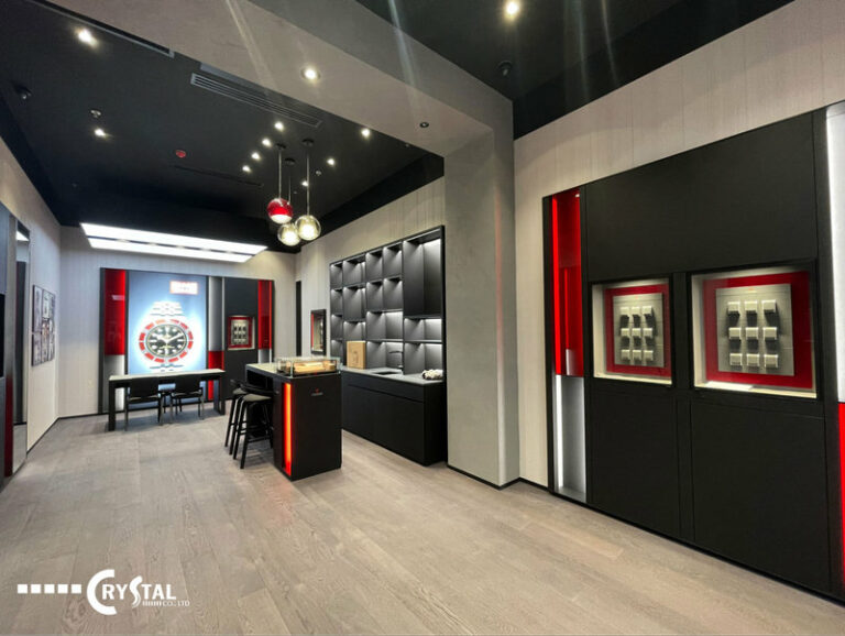 Showroom Tudor Crescent Mall hiện đại, sang trọng với tủ trưng bày màu đen, điểm nhấn đèn đỏ và khu vực tiếp khách