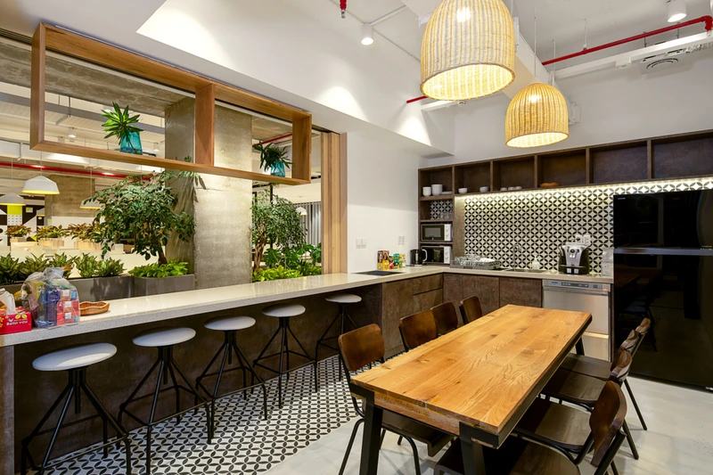 Light-toned finishes paired with tropical-inspired greenery bring a breezy, coastal resort aesthetic to the functional workspace (Source: Internet) 