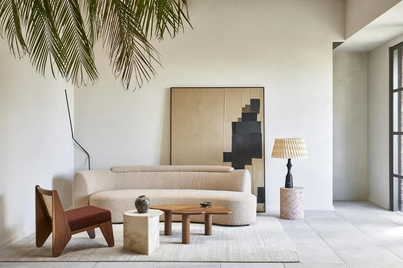 A textural boucle Wave Sofa and low-slung armchairs soften the sharp, dark steel frame of a converted warehouse, creating an organic oasis of comfort (Source: Internet)