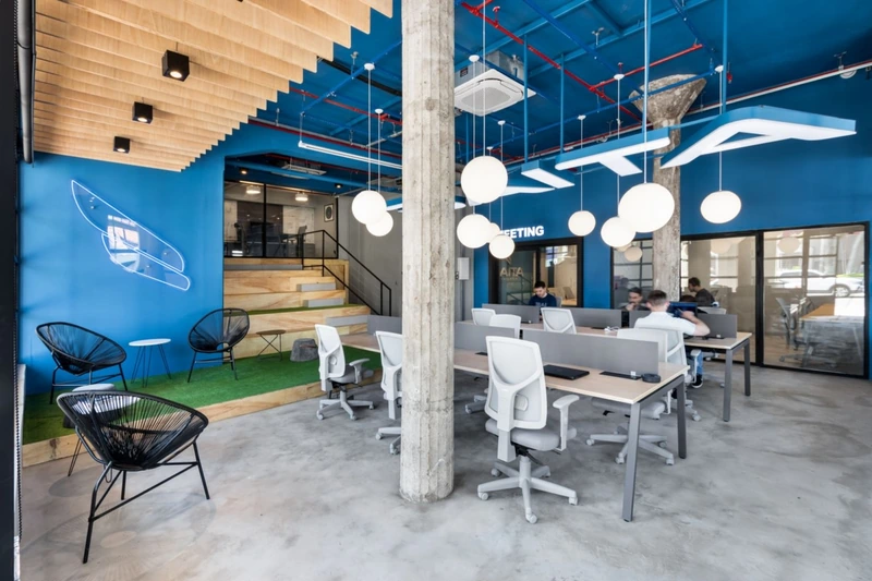 These board-formed concrete columns are treated as monumental anchor points within the open plan.