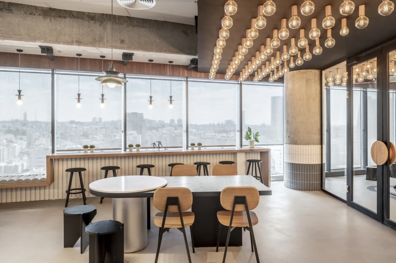 Statement lighting is one reason industrial style continues to remain visually distinctive in both offices and showrooms (Source: Internet)