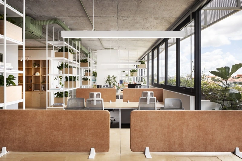A custom-designed solid birch plywood workstation merges architectural structure with tactile warmth in this modern industrial-style office (Source: Internet)