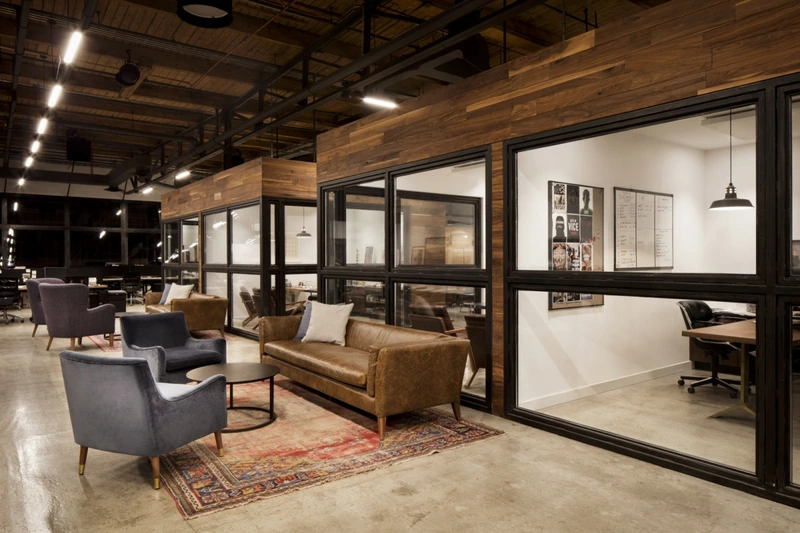 A reclaimed Persian rug paired with a leather sofa on polished concrete beautifully demonstrates how layered textures warm up raw industrial architecture (Source: Internet) 