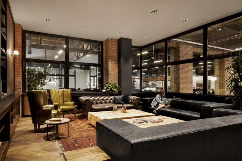 A reclaimed Persian rug paired with a leather sofa on polished concrete beautifully demonstrates how layered textures warm up raw industrial architecture (Source: Internet) 
