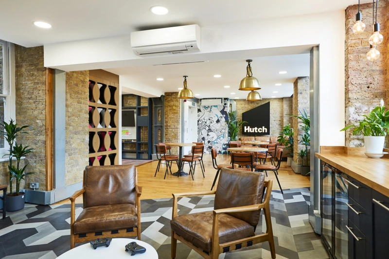 Worn tan leather and raw exposed brick combine to create a deeply welcoming atmosphere, making the office space feel genuinely inhabited. (Source: Internet)