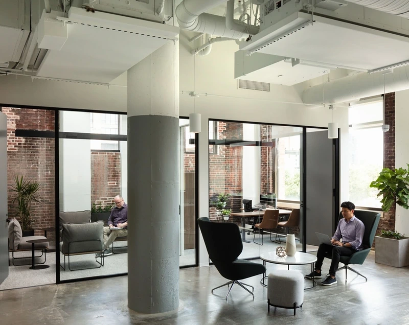 This office uses repurposed millwork and exposed brick to foster community and a rich sense of history. (Source: Internet) 
