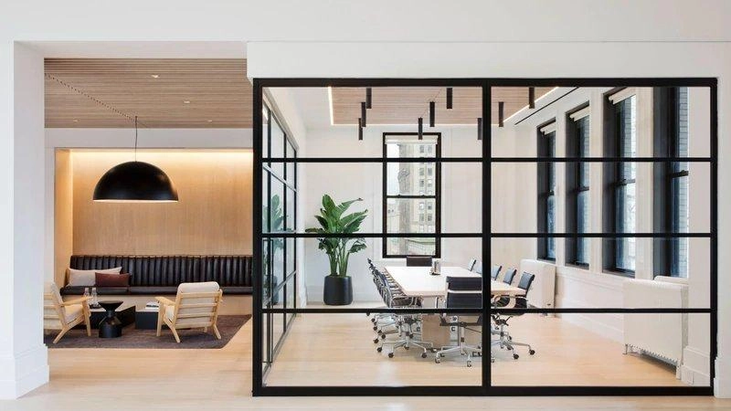 Kính, thép đen và gỗ sáng pha nhau tạo chiều sâu cho không gian văn phòng 80m2 hiện đại