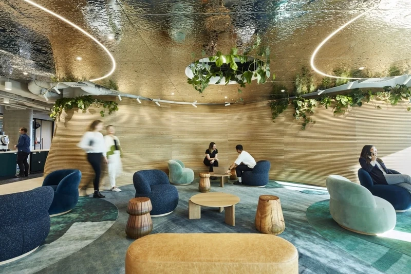 Modern collaborative lounge featuring integrated greenery, exemplifying sustainable workspace interior design principles