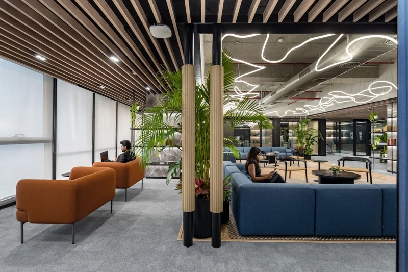 Suspended ceiling elements that break up sound waves in high-ceiling industrial offices.