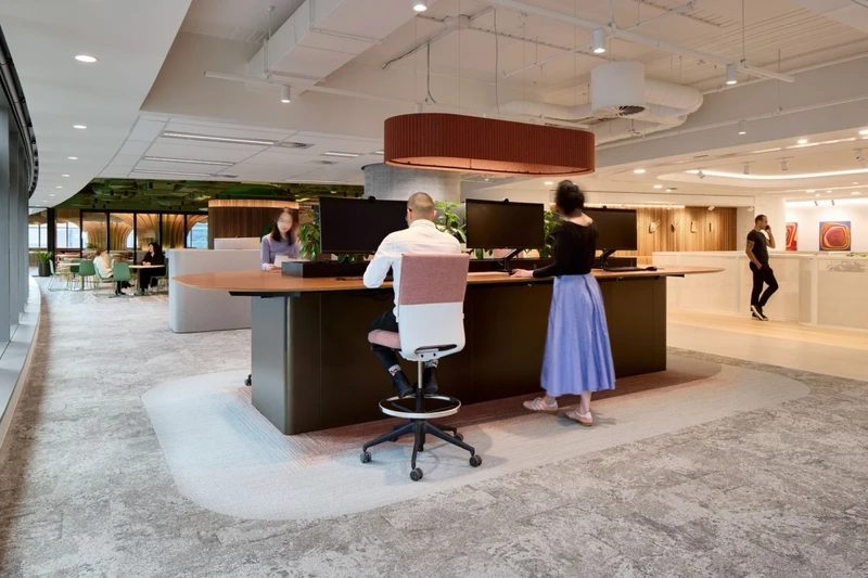 This modern interior design for workspace empowers employees to intuitively alternate between standing, perching, and reclining.